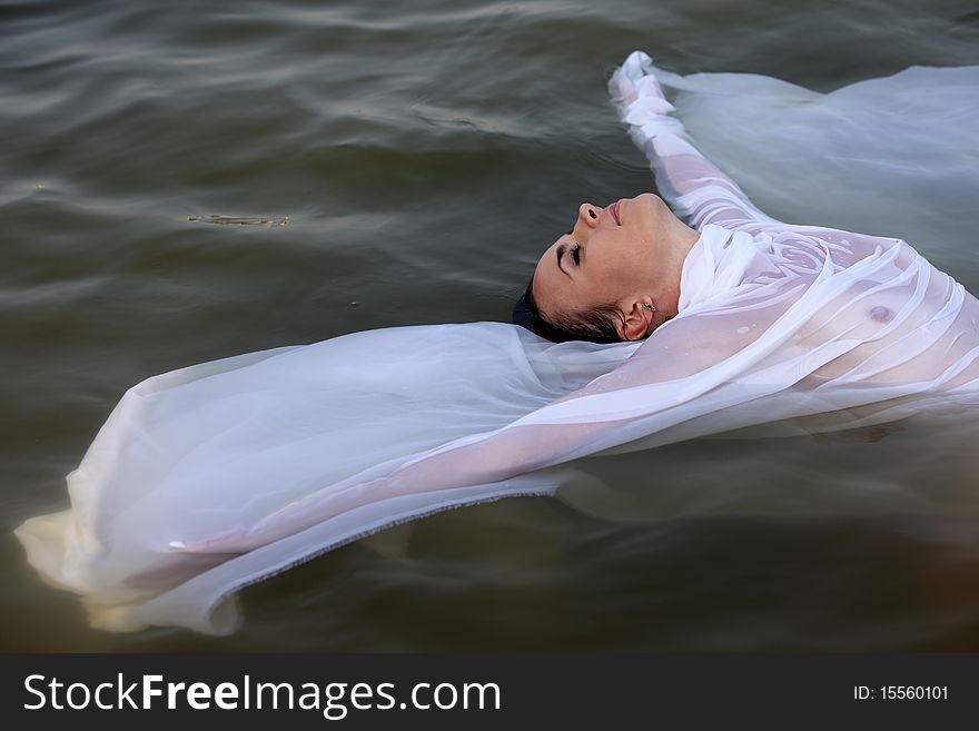 Beautiful topless woman in the river