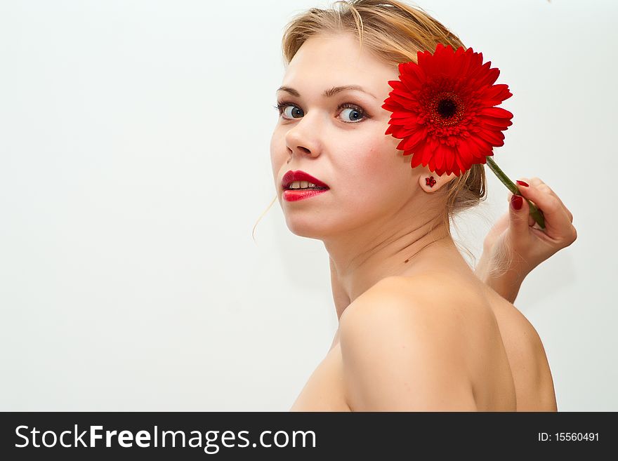 Young sensual girl with a red flower