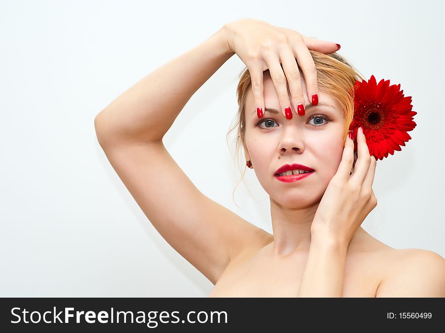 Portrait of sensual beautiful women with red daisy in her hair. Portrait of sensual beautiful women with red daisy in her hair