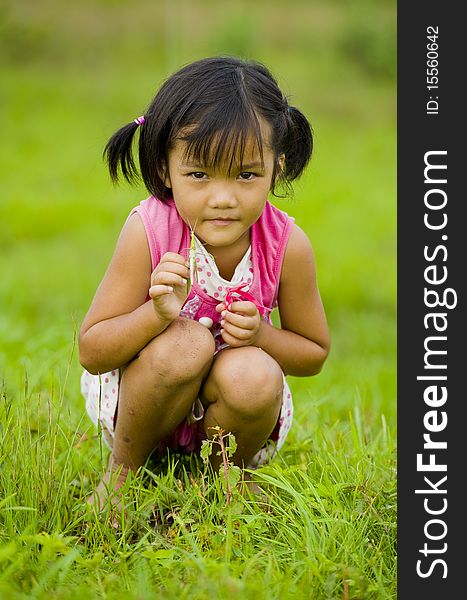 Cute asian girl holding a grasshopper