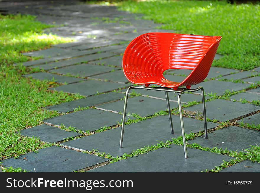 Red chair in green garden