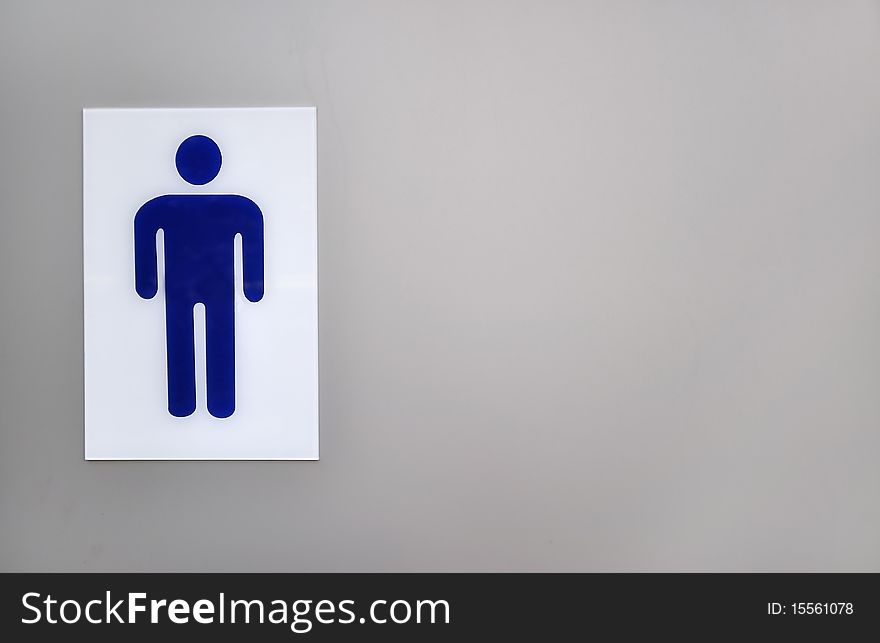 Blue gents public toilet sign on left side of grey background