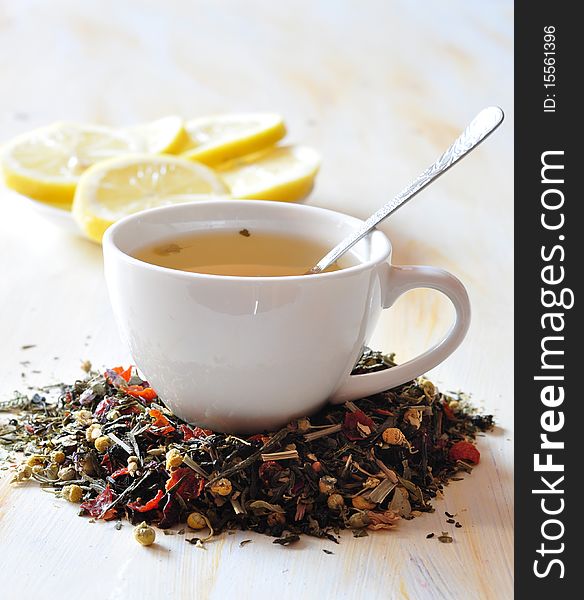 Cup with herbal tea, alongside lemon