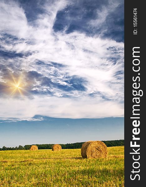 Field, three bales and amazing blue sky with white clouds. Field, three bales and amazing blue sky with white clouds.