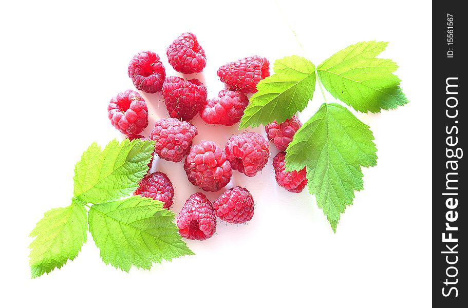 Berries of raspberry and two leaves on a white background. Berries of raspberry and two leaves on a white background