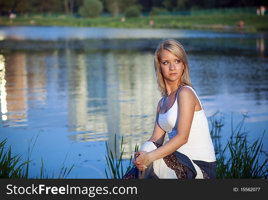 Attractive girl relaxing at the lake. Attractive girl relaxing at the lake