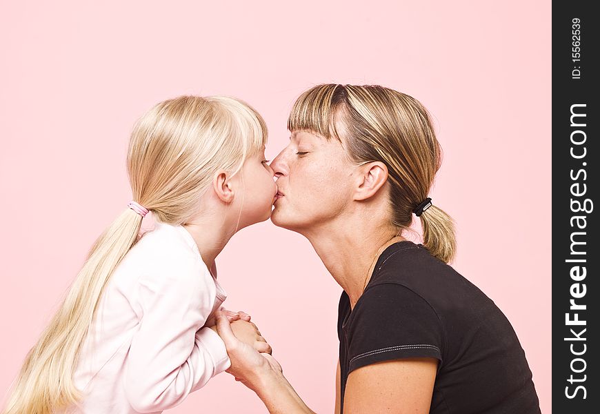 Mother and daughter on pink background
