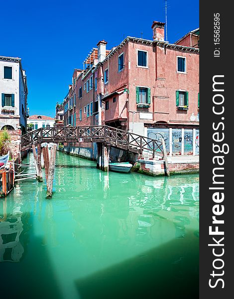Venice canal with bridge and houses in water