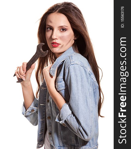 Young beautiful woman in jeans jacket with wrench. Young beautiful woman in jeans jacket with wrench