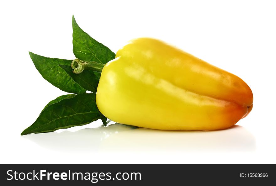 Yellow pepper and green leaf isolated on white background