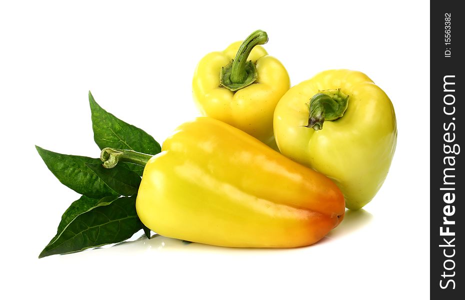 Yellow pepper and green leaf isolated on white background