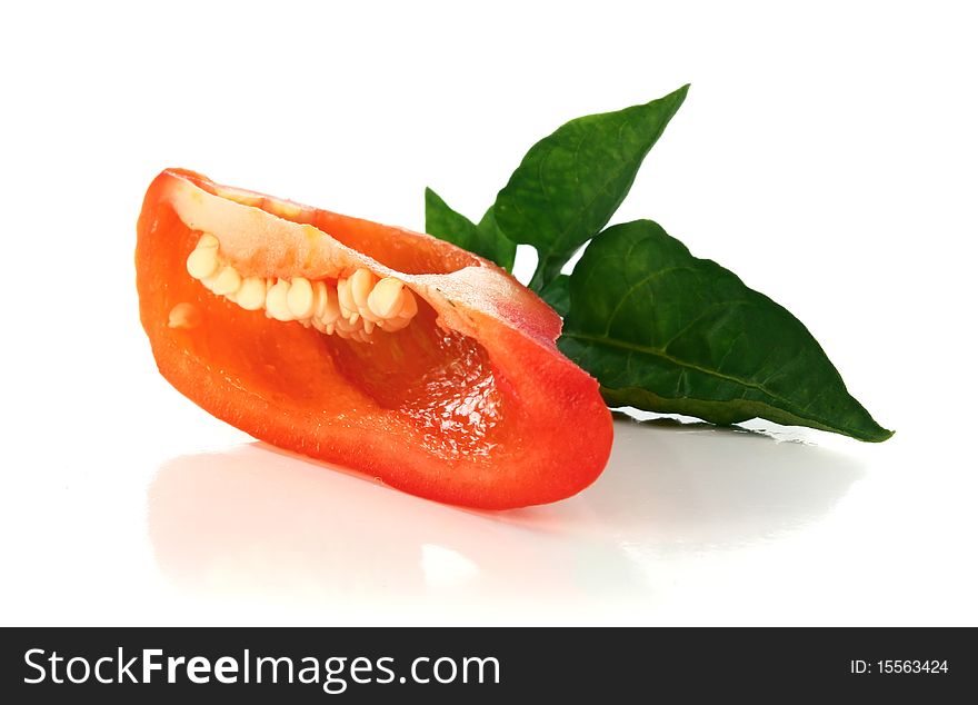Red cut pepper and green leaf isolated on white background