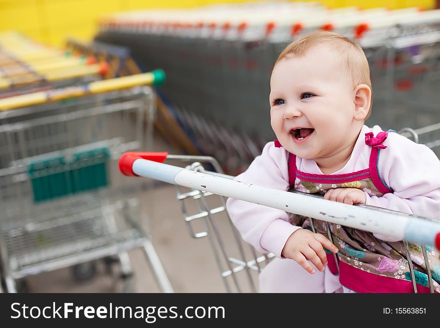 Beautiful baby girl in shopping cart - trolley