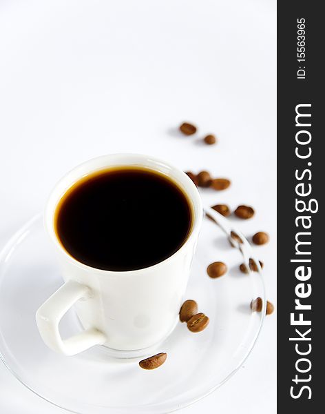 Cup of aromatic coffee with coffe beans
