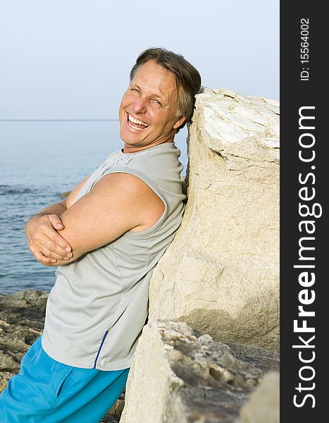 A color portrait photo of a happy laughing mature man in his forties relaxing at the beach. A color portrait photo of a happy laughing mature man in his forties relaxing at the beach.