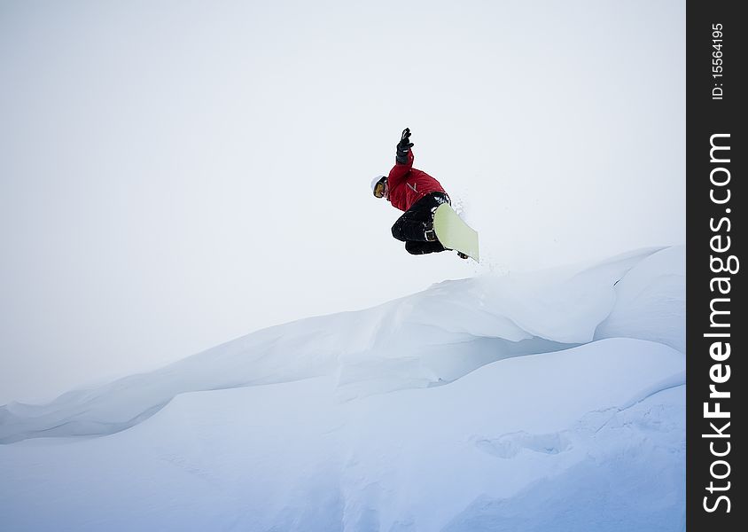 Snowboarder jumping through air with deep blue sky in background