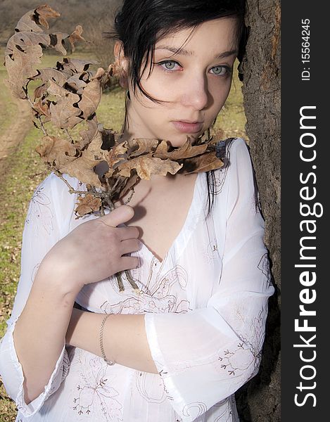 Beautiful Brunette Girl with dry leaves