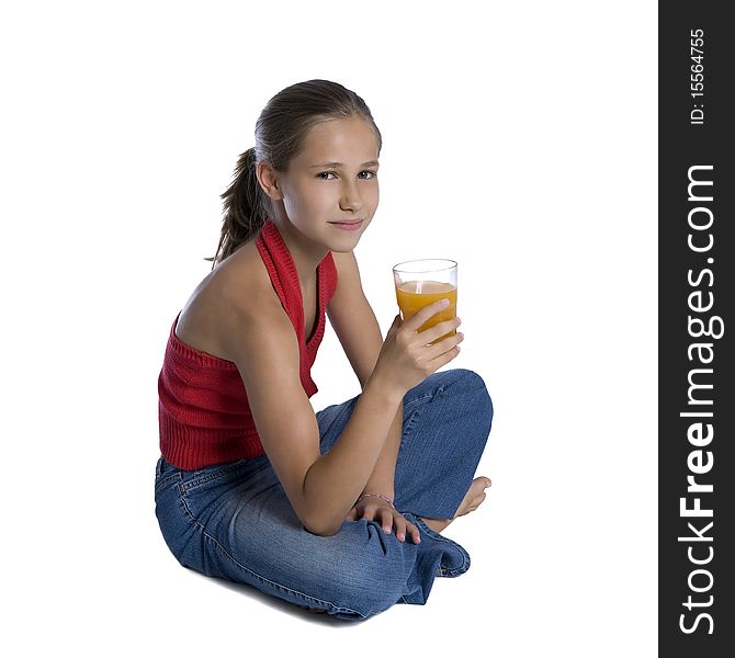 Young girl sitting with glass of orange juice