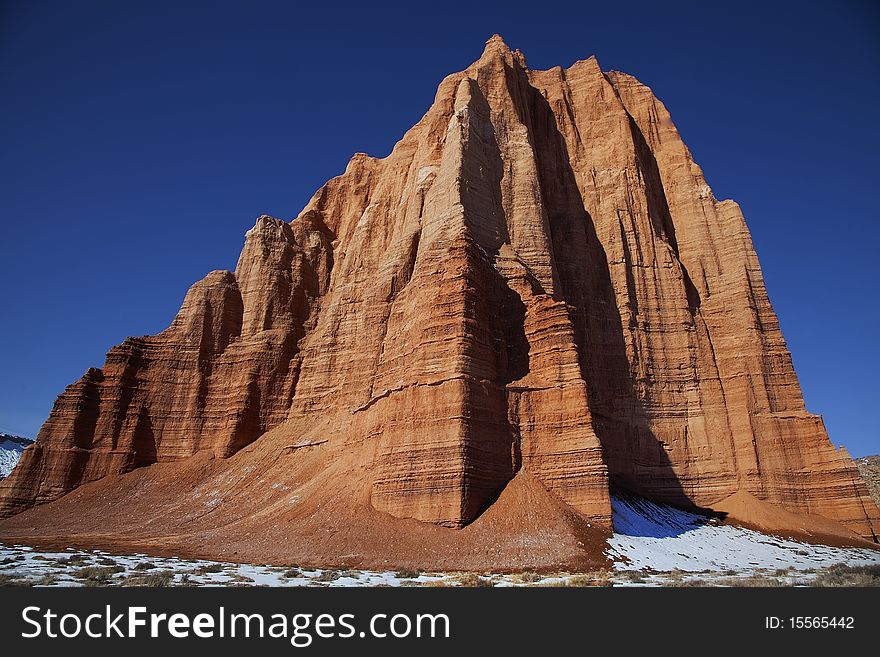 View of the red rock formations in Capitol Reef National Park with blue skyï¿½s and clouds and snow