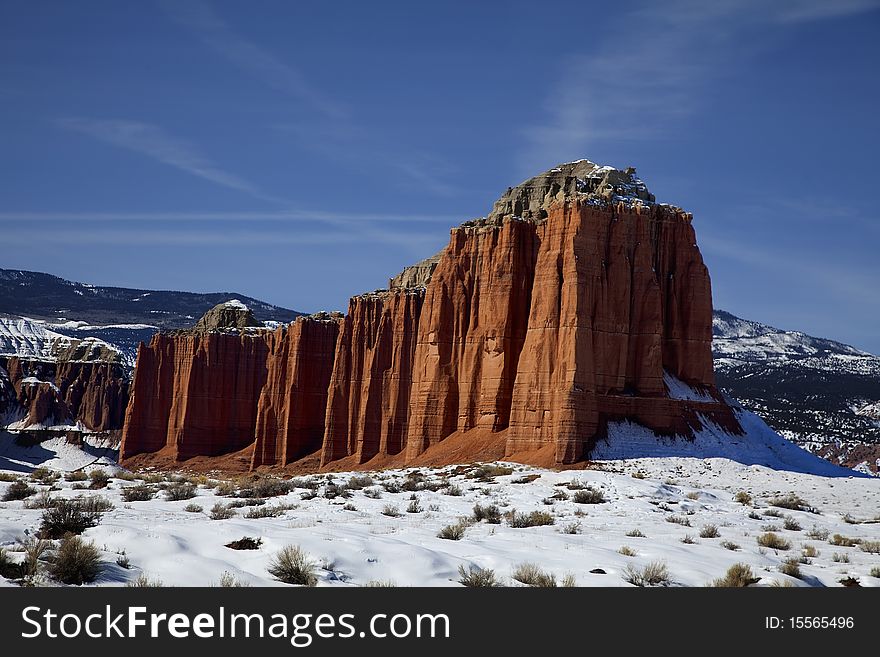 View of the red rock formations in Capitol Reef National Park with blue sky�s and clouds and snow