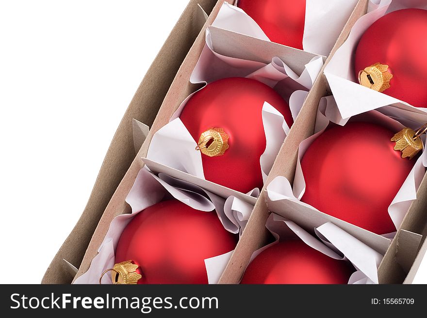 Boxes with red baubles isolated on a white background.