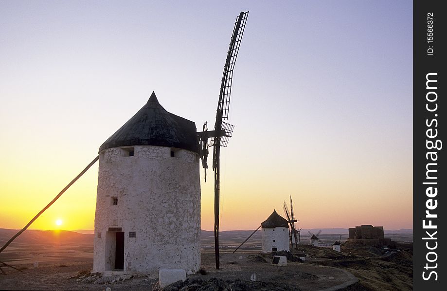 Beautifull old windmill in front of a red sunset.