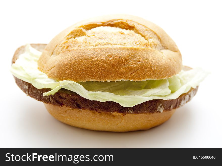 Roll and wheat bread with lettuce leaf