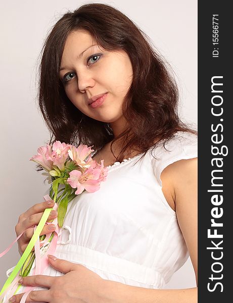 Portrait of beautiful woman in white dress with flower