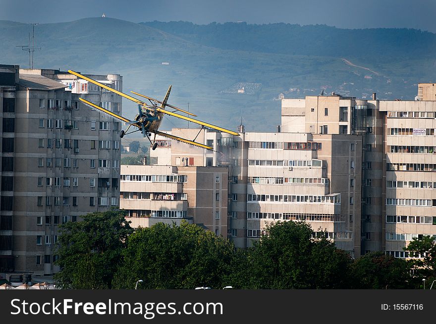 Photo of an Antonov 2 plane, flying between the buildings, spreading mosquito poison. Photo of an Antonov 2 plane, flying between the buildings, spreading mosquito poison