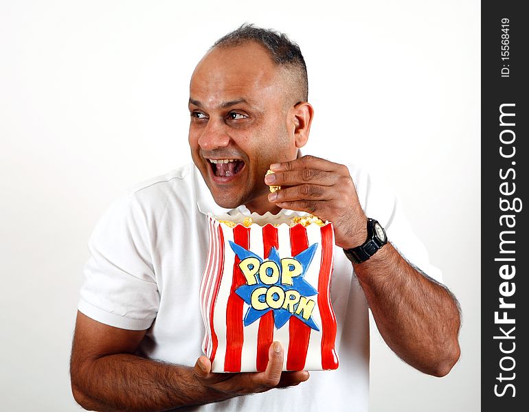 Office worker eating popcorn and enjoying