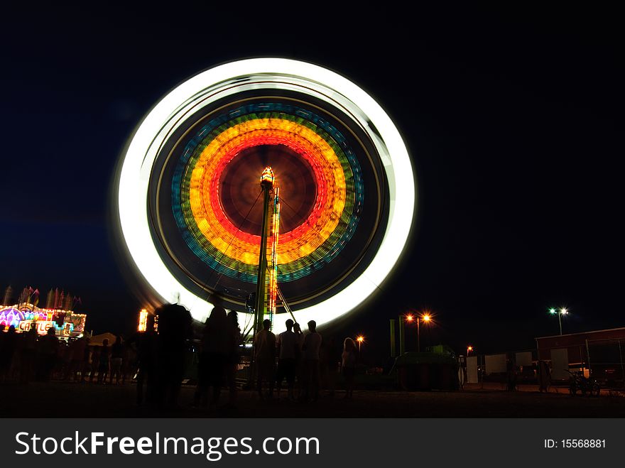 Ferris wheel motion blur at night at carnival. Ferris wheel motion blur at night at carnival