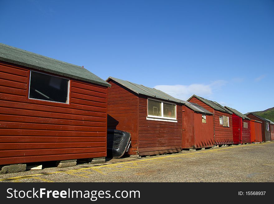 Red beach huts, blue sky