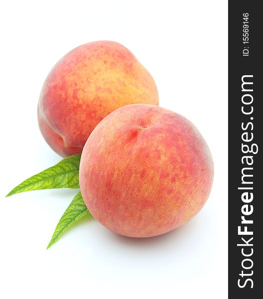 Two ripe and sweet peaches close up