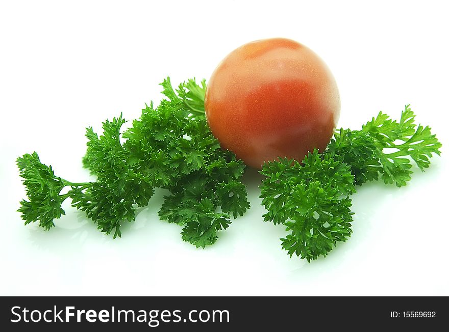 Tomatoes with greens on white background