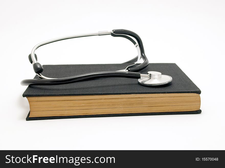 Stethoscope over book isolated on white background