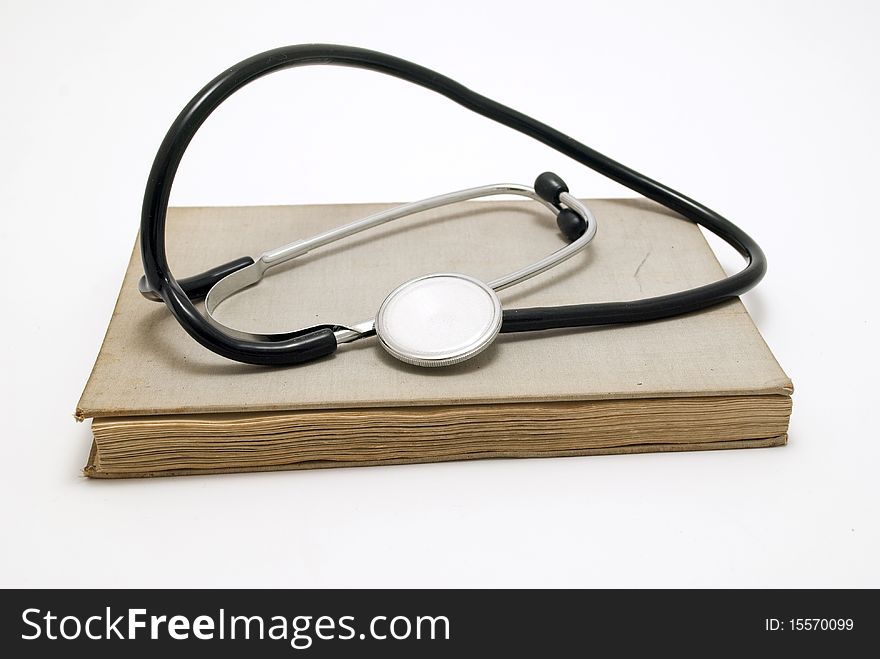 Stethoscope over book isolated on white background