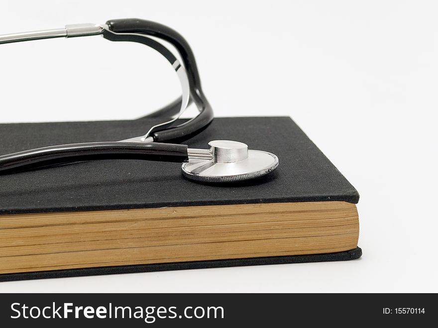 Stethoscope over book isolated on white background