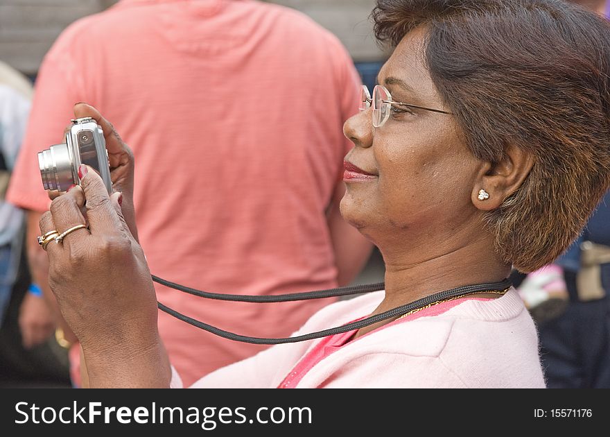 An image of a woman taking pictures of traction Engines at Pickering using a point and shoot camera. An image of a woman taking pictures of traction Engines at Pickering using a point and shoot camera.