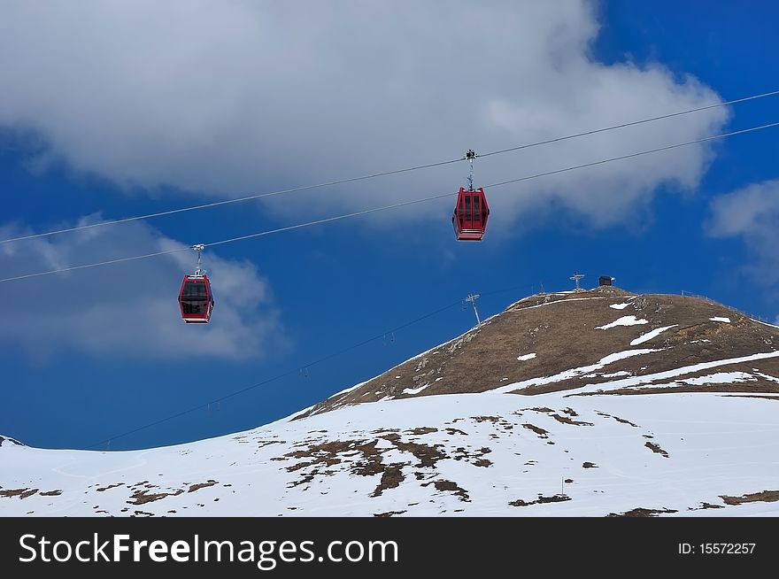 Red cable car on snow mountain