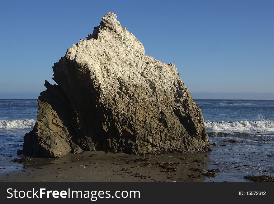 Guano covered rock at beach. Guano covered rock at beach