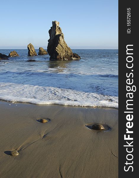 Closeup of pebbles and water on beautiful beach. Closeup of pebbles and water on beautiful beach