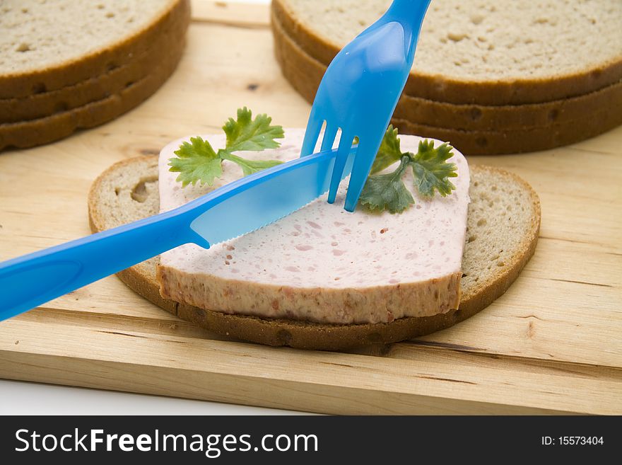 Wheat bread with liver cheese and cutlery. Wheat bread with liver cheese and cutlery