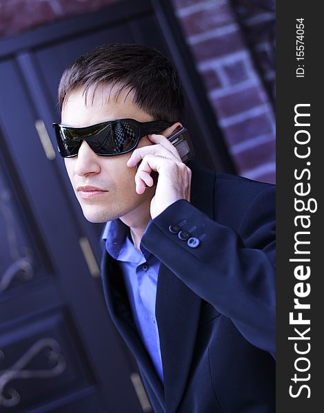 Man in black glasses talking on the phone