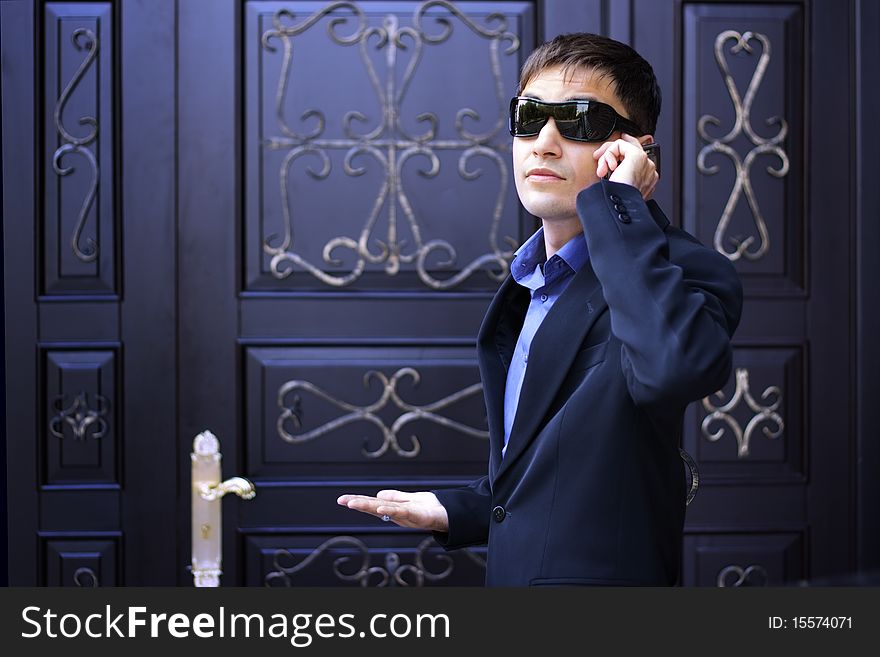 Man in black glasses talking on the phone