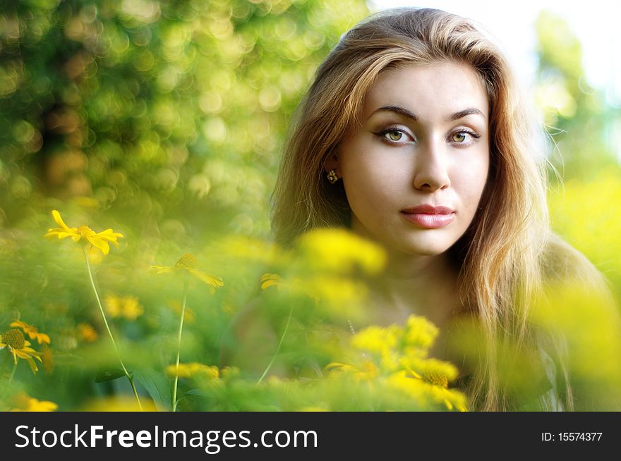 Beautiful girl with yellow flowers at city park
