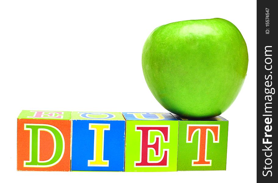 Green apple and cubes with letters in front of a white background - diet. Green apple and cubes with letters in front of a white background - diet