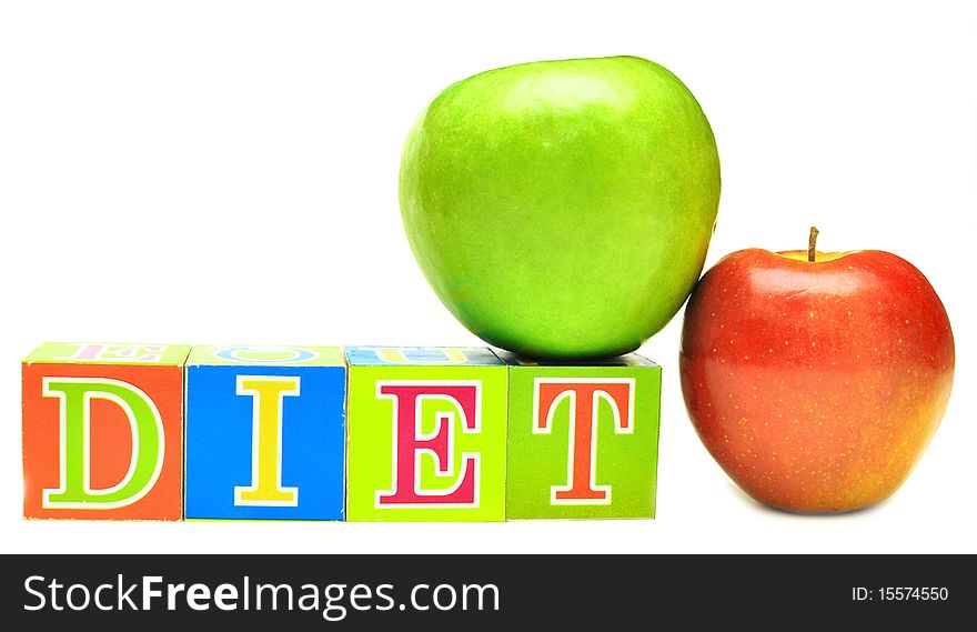 Green and red apple and cubes with letters in front of a white background - diet. Green and red apple and cubes with letters in front of a white background - diet