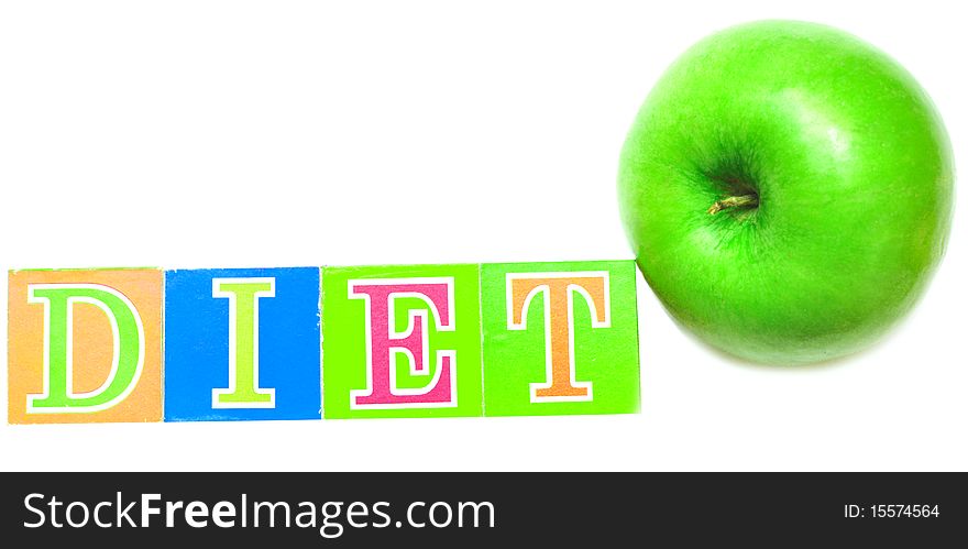 Green apple and cubes with letters in front of a white background - diet. Green apple and cubes with letters in front of a white background - diet