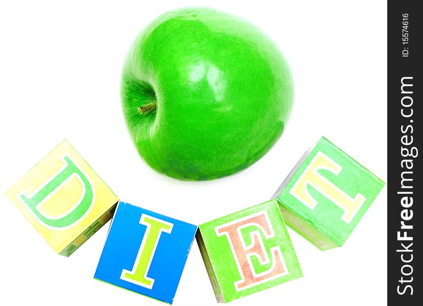 Green apple and cubes with letters in front of a white background - diet. Green apple and cubes with letters in front of a white background - diet