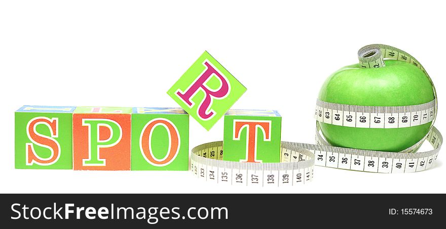 Tape measure wrapped around apple green and cubes with letters - sport. Tape measure wrapped around apple green and cubes with letters - sport